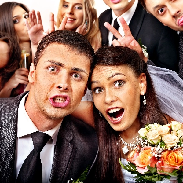 This is a wedding party taking a Photo Booth picture. 